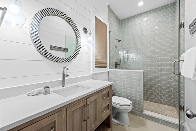 bathroom featuring tile patterned floors, a shower stall, toilet, and vanity