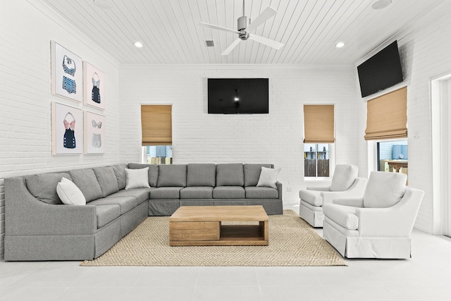 living room featuring tile patterned flooring, wood ceiling, and brick wall