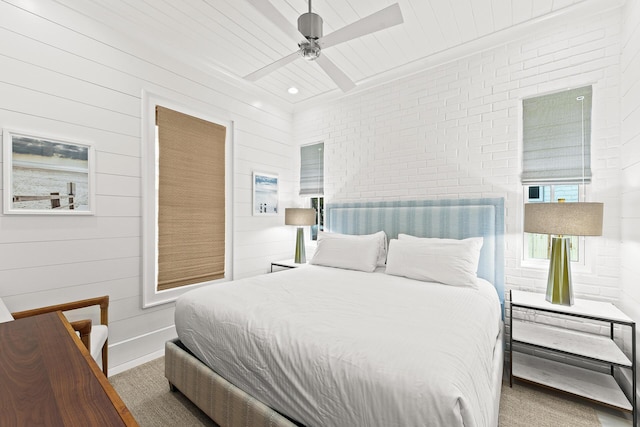 bedroom featuring wood ceiling, baseboards, brick wall, and ceiling fan