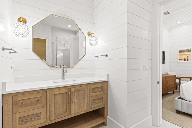 full bathroom featuring recessed lighting, connected bathroom, a walk in shower, and vanity