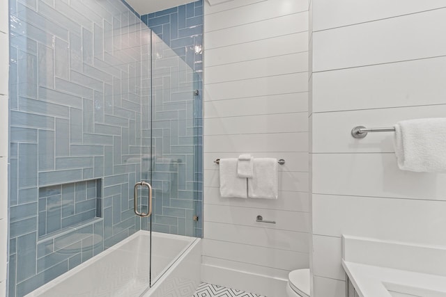 bathroom featuring an enclosed shower and toilet