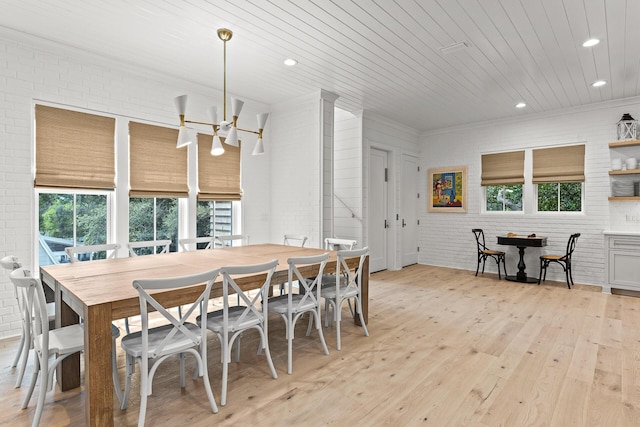 dining area featuring light wood-style floors, a healthy amount of sunlight, brick wall, and wooden ceiling