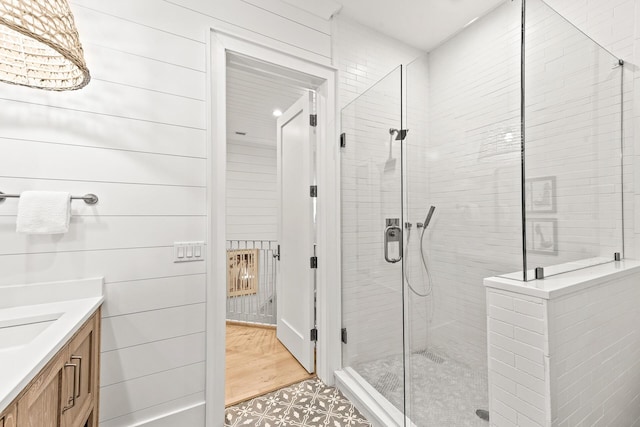 full bathroom featuring a stall shower and vanity