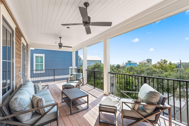 wooden terrace featuring ceiling fan and outdoor lounge area