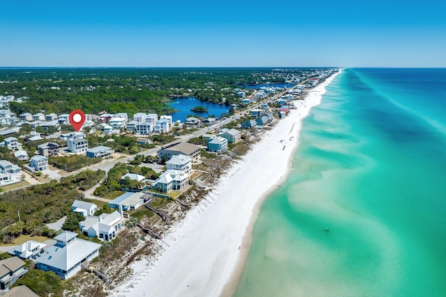 birds eye view of property featuring a view of the beach and a water view