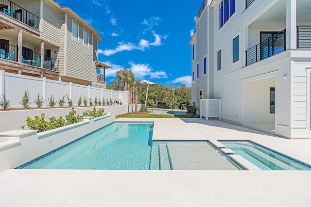 view of swimming pool featuring a patio, fence, and a fenced in pool