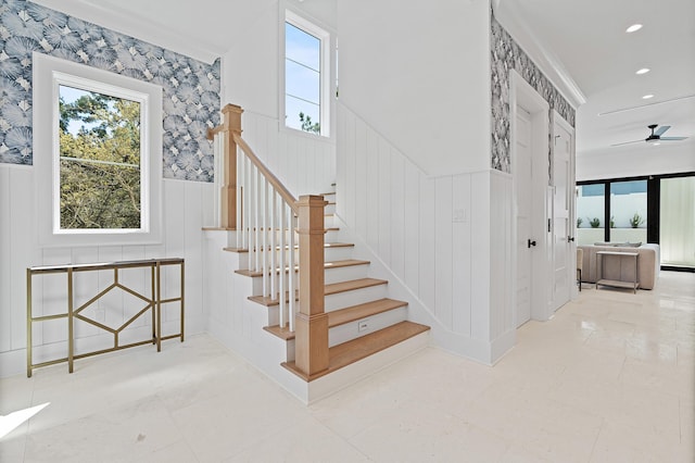 staircase featuring a wainscoted wall, recessed lighting, wallpapered walls, and ceiling fan