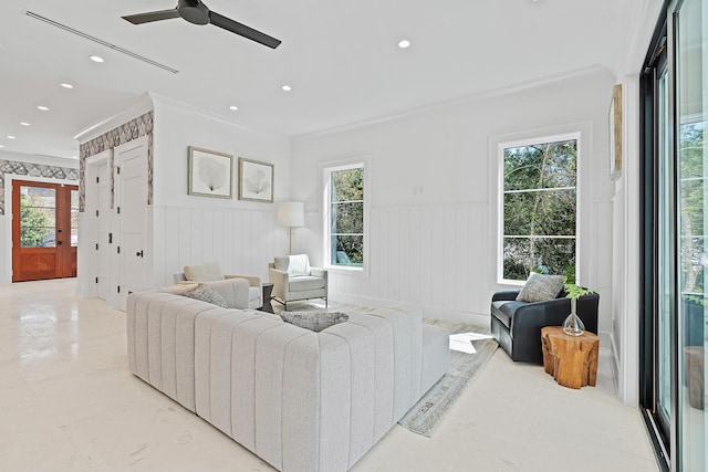 living room featuring a wainscoted wall, recessed lighting, a ceiling fan, and ornamental molding