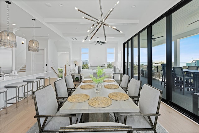 dining space featuring recessed lighting, ceiling fan with notable chandelier, stairway, and light wood-type flooring