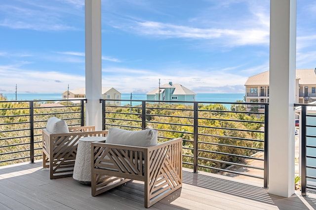 wooden terrace featuring a water view