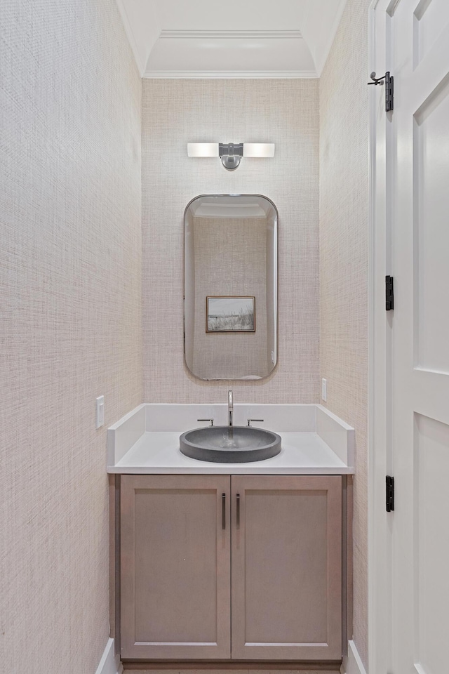 bathroom with ornamental molding and vanity