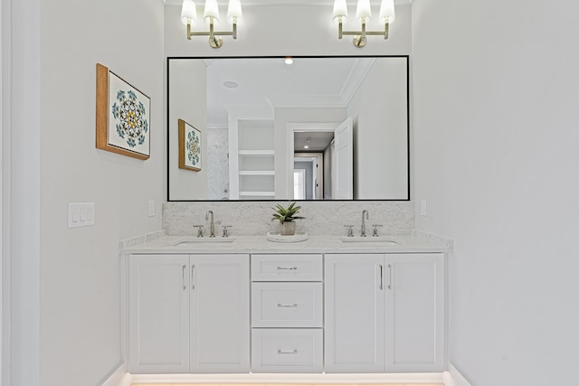 full bathroom with a sink, backsplash, double vanity, and crown molding