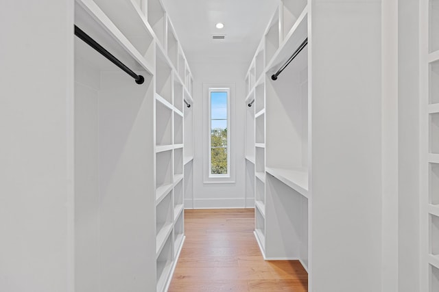 spacious closet with light wood-style flooring and visible vents