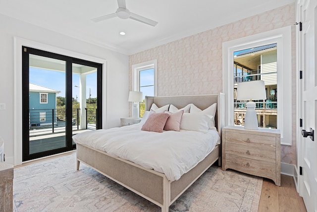 bedroom featuring light wood-style floors, crown molding, wallpapered walls, baseboards, and access to exterior