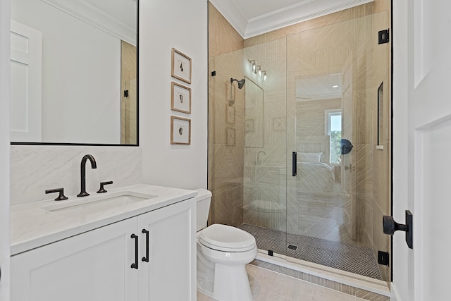 full bath featuring vanity, toilet, ornamental molding, and a shower stall