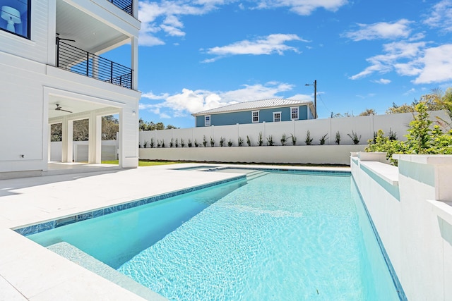 view of swimming pool featuring a fenced in pool, a patio, a ceiling fan, and a fenced backyard