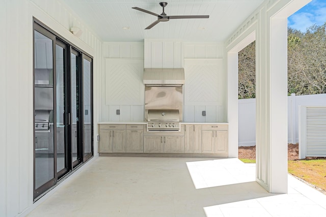 view of patio featuring exterior kitchen, grilling area, ceiling fan, and fence