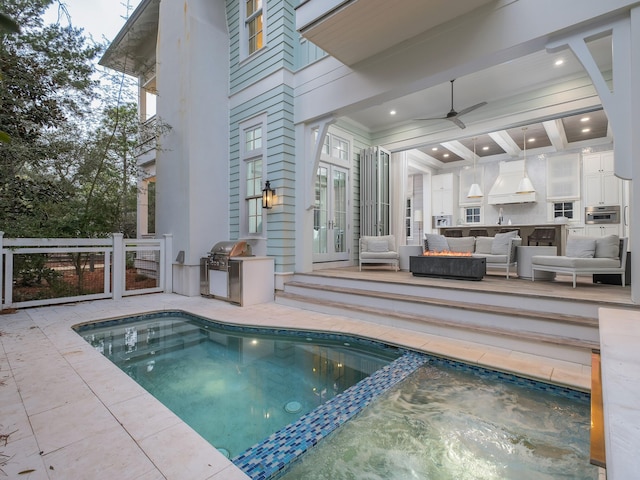 view of swimming pool featuring an outdoor living space, a pool with connected hot tub, french doors, a patio area, and area for grilling