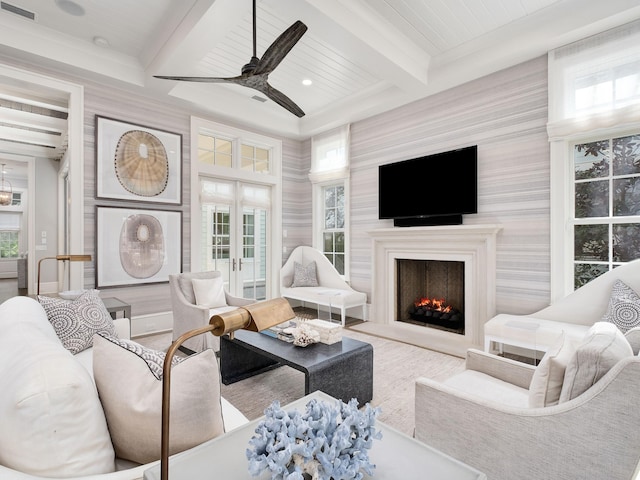 living area with visible vents, beam ceiling, recessed lighting, a warm lit fireplace, and french doors