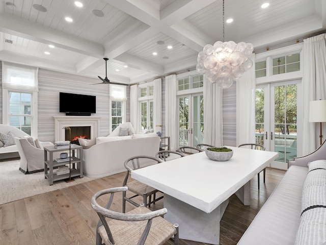 dining room featuring french doors, wood-type flooring, coffered ceiling, and beam ceiling