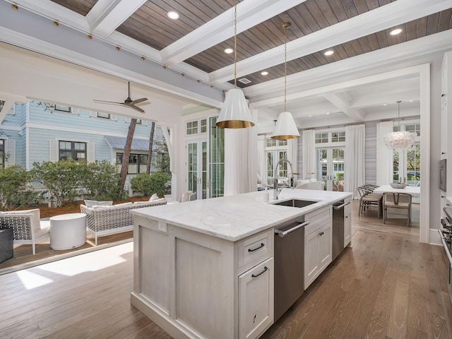 kitchen with dark wood finished floors, open floor plan, dishwasher, and a sink