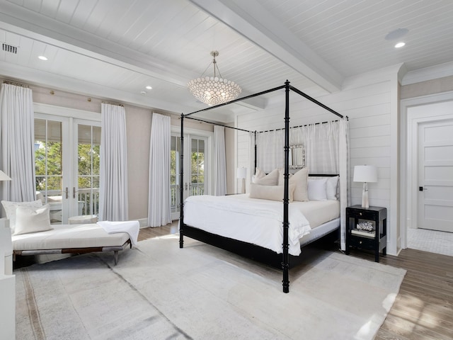 bedroom with beam ceiling, recessed lighting, french doors, and wood finished floors