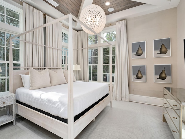 carpeted bedroom with wood ceiling and baseboards