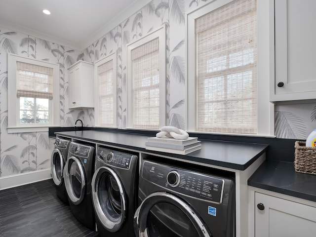 laundry area featuring ornamental molding, washer and dryer, cabinet space, wallpapered walls, and baseboards