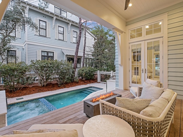 view of swimming pool featuring french doors, an outdoor fire pit, and a jacuzzi