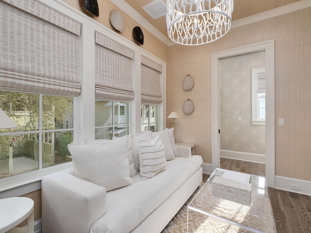 living room featuring wallpapered walls, plenty of natural light, wood finished floors, and baseboards