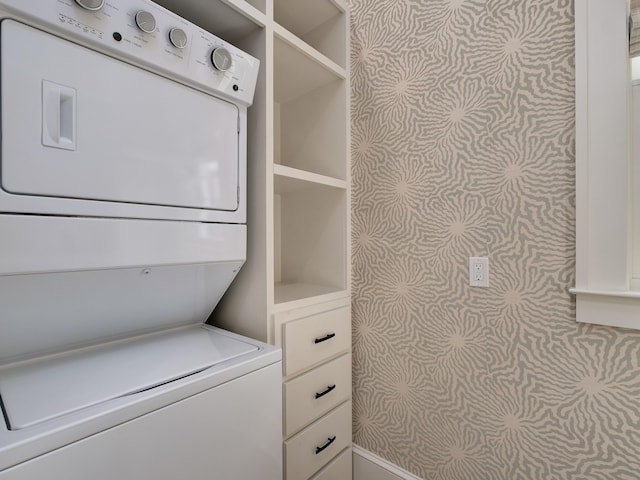 clothes washing area featuring laundry area and stacked washer and dryer