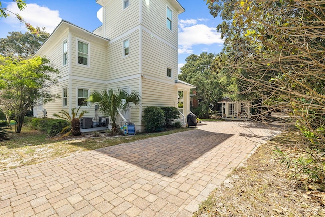 view of side of property with central AC unit