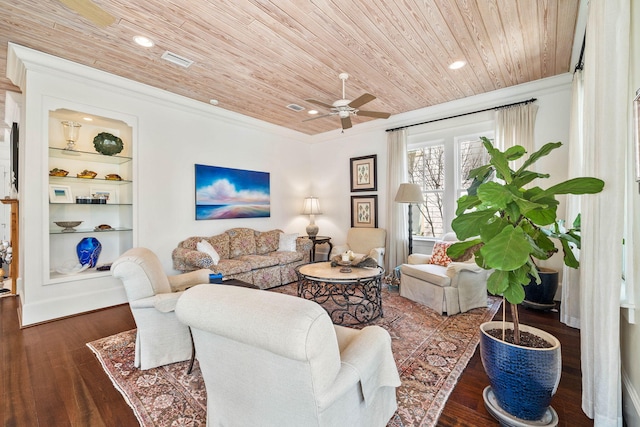 living area with visible vents, built in features, wood finished floors, wooden ceiling, and crown molding