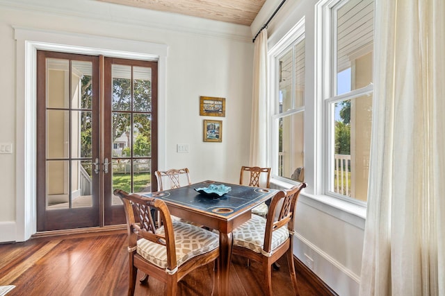 dining area with a healthy amount of sunlight, french doors, dark wood-type flooring, and baseboards