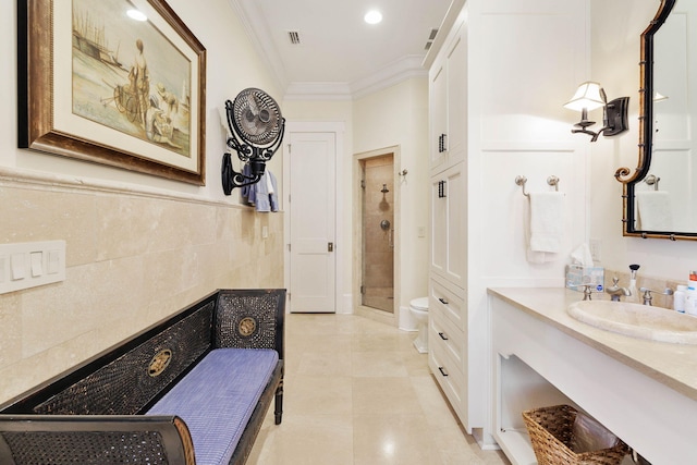 full bathroom with vanity, a stall shower, tile patterned flooring, crown molding, and toilet