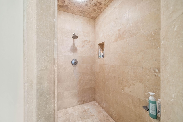 bathroom with a tile shower