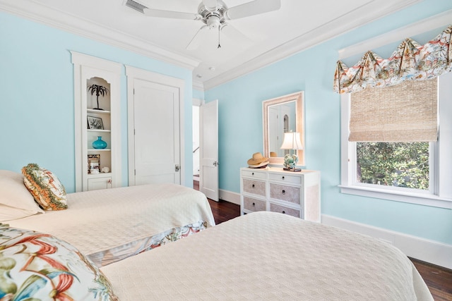 bedroom featuring visible vents, dark wood-type flooring, a ceiling fan, crown molding, and baseboards