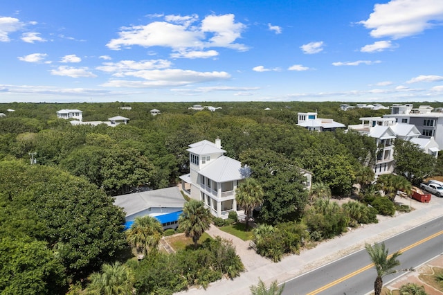 birds eye view of property with a view of trees