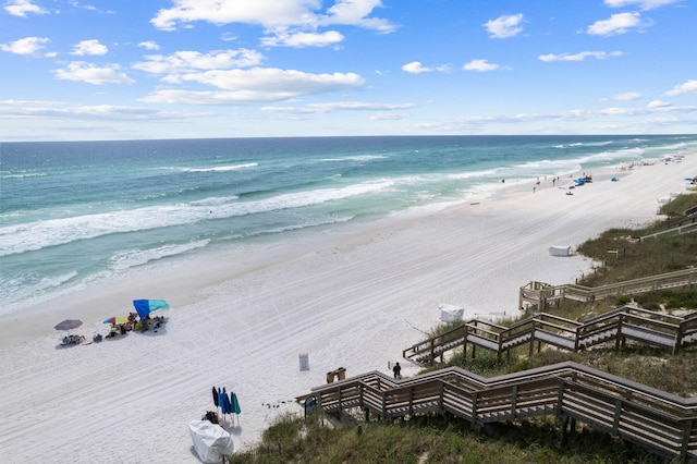 drone / aerial view featuring a beach view and a water view