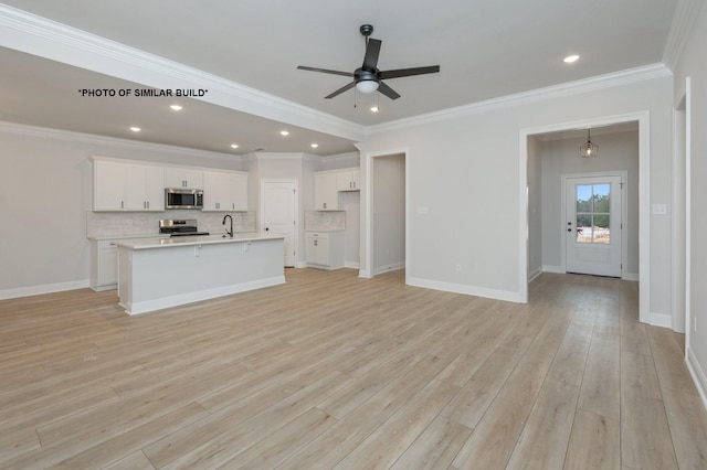 unfurnished living room with ceiling fan, baseboards, light wood finished floors, and ornamental molding