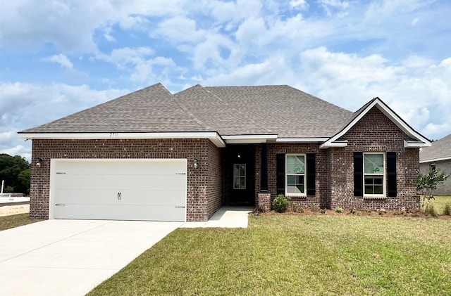 2711 Louis Cir, Crestview, FL 32536 - view of front of home with brick siding, roof with shingles, a front lawn, driveway, and a garage