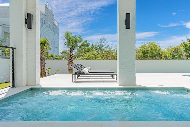 view of swimming pool with a patio, a pool, and fence
