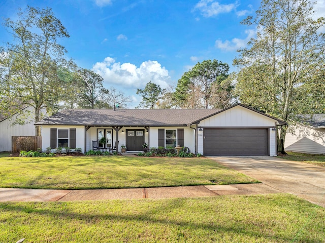 single story home with concrete driveway, a garage, and a front yard