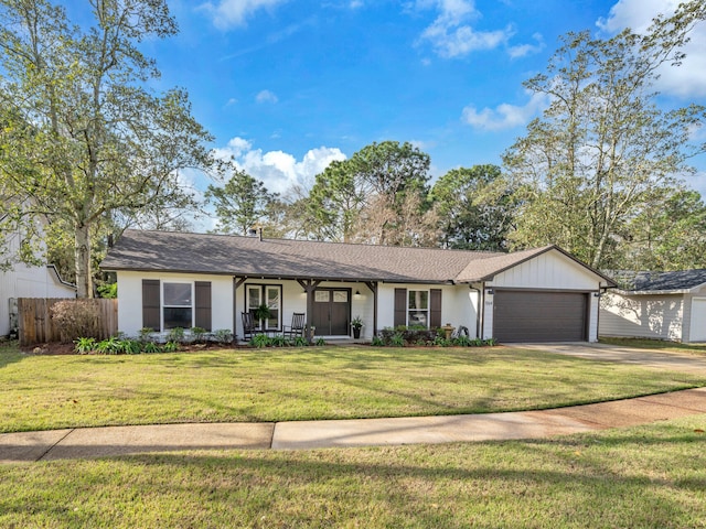 ranch-style house with a front yard, fence, driveway, a porch, and an attached garage