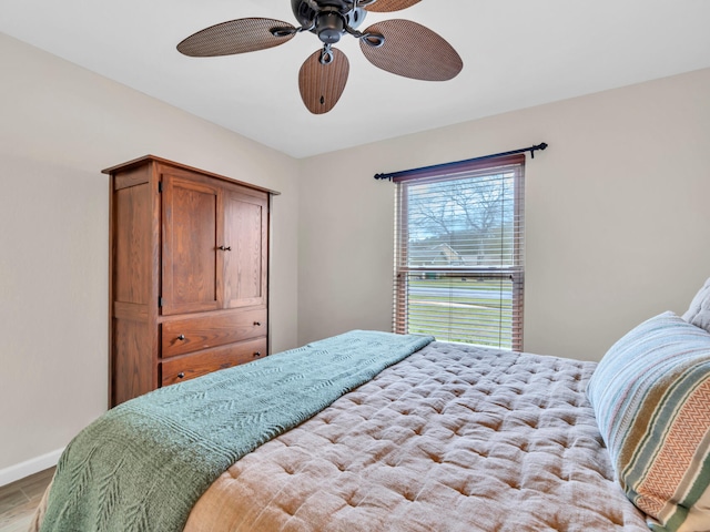 bedroom with baseboards and a ceiling fan