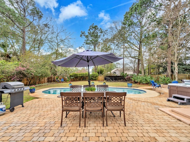 view of pool with a patio, a fenced in pool, outdoor dining area, a fenced backyard, and a hot tub