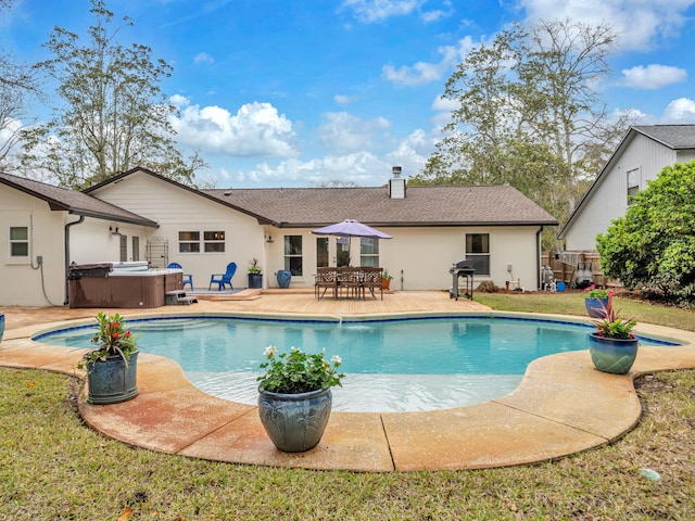 outdoor pool with a patio area, a grill, a hot tub, and fence