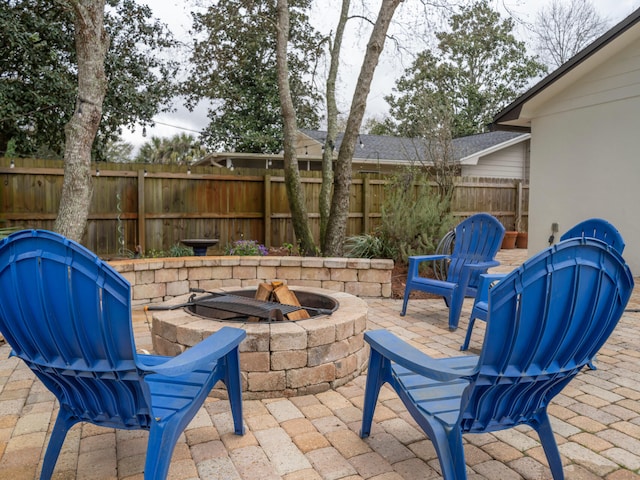 view of patio featuring fence and an outdoor fire pit