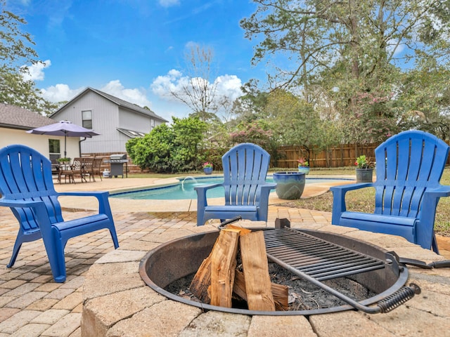 view of patio / terrace featuring area for grilling, a fenced in pool, and fence