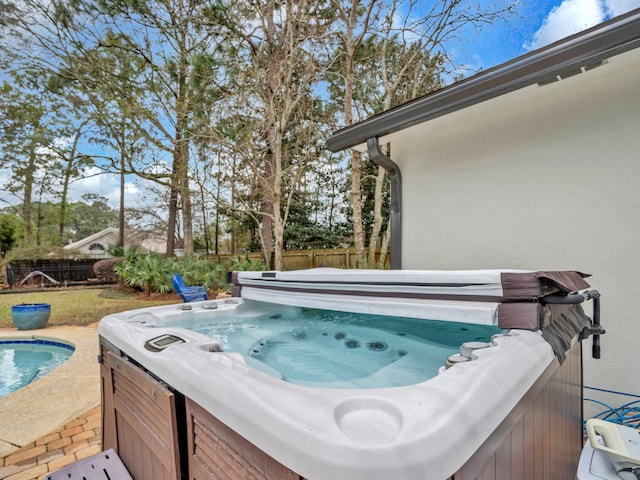 view of patio with fence and a hot tub